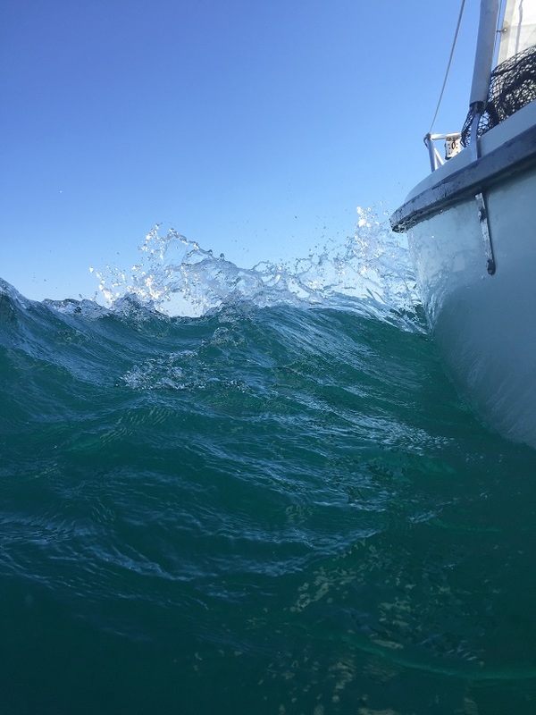 water splashing off sailboat bow